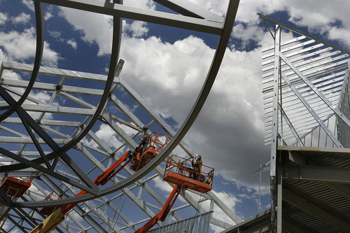 Scott Sommerdorf  |  The Salt Lake Tribune             
Workers finish off some iron work at the The Outlets at Traverse Mountain prior to a press conference where an announcement of an expansion and new retailers was made, Thursday, June 28, 2012.