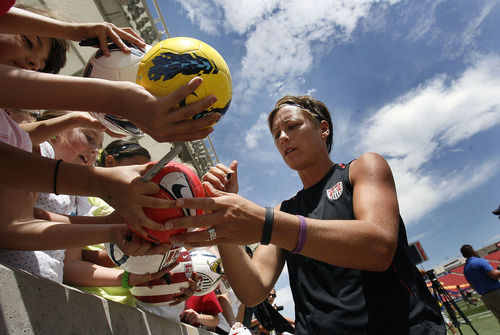 Scott Sommerdorf  |  The Salt Lake Tribune             
Abby Wambach signs fan's items after practice. The U.S. Women's national soccer team held its final practice Friday, June 29, 2012 in advance of its Olympic send-off match against Canada at Rio Tinto Stadium on Saturday. The practice session was open to the public.