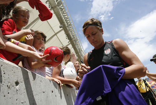 Scott Sommerdorf  |  The Salt Lake Tribune             
Abby Wambach signs fan's items after practice. The U.S. Women's national soccer team held its final practice Friday, June 29, 2012 in advance of its Olympic send-off match against Canada at Rio Tinto Stadium on Saturday. The practice session was open to the public.
