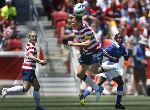 Scott Sommerdorf  |  The Salt Lake Tribune             
USA forward Abby Wambach (14) heads the ball near midfield during second half play. The U.S. women's national team beat Canada 2-1 in its final match before going to the London Olympics, Saturday, June 30, 2012.