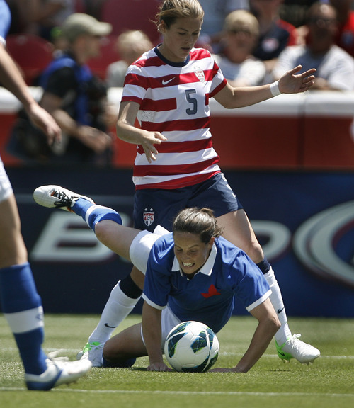 Scott Sommerdorf  |  The Salt Lake Tribune             
USA defender Kelley O'Hara (5) battles with Canada defender Emily Zurrer (2) during first half play. The U.S. women's national team beat Canada 2-1 in its final match before going to the London Olympics, Saturday, June 30, 2012.