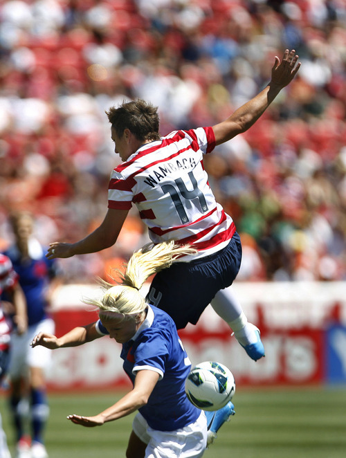 Scott Sommerdorf  |  The Salt Lake Tribune             
USA forward Abby Wambach (14) is up-ended on a play during first half play. The U.S. women's national team held a 1-0 lead at the half over Canada in its final match before going to the London Olympics, Saturday, June 29, 2012.