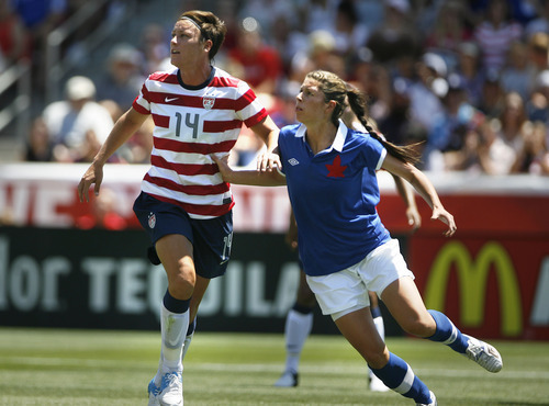 Scott Sommerdorf  |  The Salt Lake Tribune             
USA forward Abby Wambach (14) was closely marked during most of the game as the U.S. women's national beat Canada 2-1 in its final match before going to the London Olympics, Saturday, June 30, 2012.