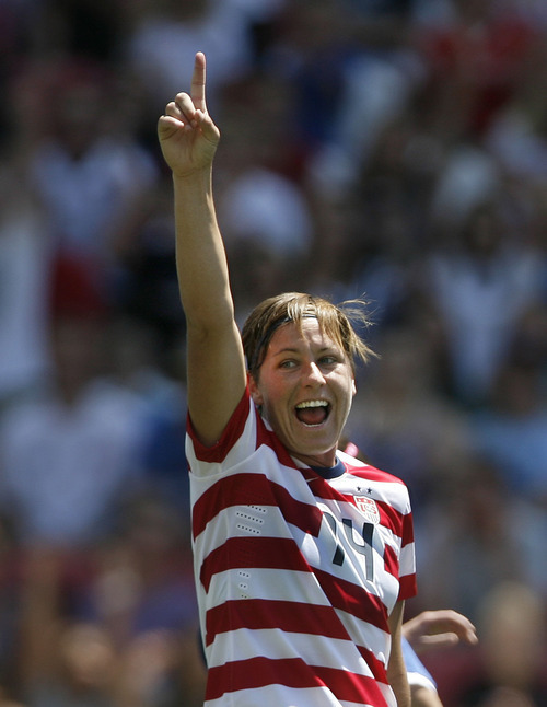 Scott Sommerdorf  |  The Salt Lake Tribune             
USA forward Abby Wambach (14) celebrates the first half own-goal put in by Canada midfielder Carmelina Moscato (4) to give the USA the early lead. The U.S. women's national team held a 1-0 lead at the half over Canada in its final match before going to the London Olympics, Saturday, June 29, 2012.