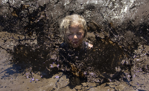 Kim Raff | The Salt Lake Tribune
Kids jump into a mud pit during the Kids Fit Junior Spartan Race at Soldier Hollow in Midway on Saturday, June 30, 2012.