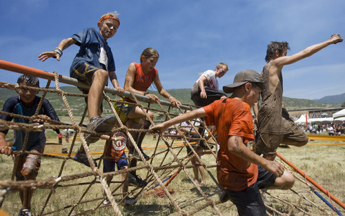 Kim Raff | The Salt Lake Tribune
Kids jump over obstacles during the 1 mile Kids Fit Varsity Spartan Race at Soldier Hollow in Midway on Saturday, June 30, 2012.