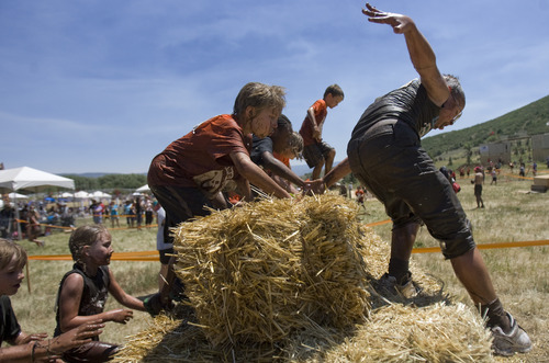 Kim Raff | The Salt Lake Tribune
Kids jump over a hay bale obstacle during the 1 mile Kids Fit Varsity Spartan Race at Soldier Hollow in Midway on Saturday, June 30, 2012.