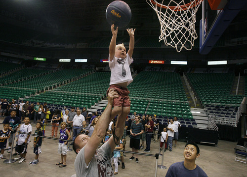 Scott Sommerdorf  |  The Salt Lake Tribune             
Young Owen Wilson is lifted up by his father Matt Wilson of Salt Lake City during an NBA draft party for Utah Jazz fans at EnergySolutions Arena in Salt Lake City on Thursday, June 28, 2012.