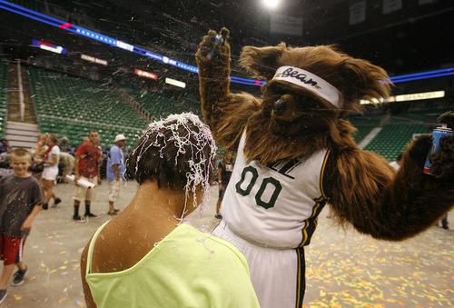 Scott Sommerdorf  |  The Salt Lake Tribune             
The Jazz Bear doused Anastasia Scott with silly string as he fills time before the Jazz pick at #47, at least an hour later. The Utah Jazz held an NBA draft party for fans at EnergySolutions Arena, Thursday, June 28, 2012.