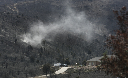Scott Sommerdorf  |  The Salt Lake Tribune             
Herriman residents who did not lose their homes said they now fear the loss of soil from winds like this on their torched hillside near Rosecrest Drive in Herriman, Sunday, July 1, 2012.