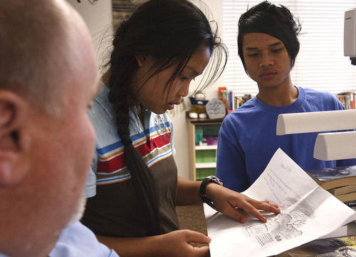Leah Hogsten  |  The Salt Lake Tribune
KaPaw Htoo gets help with his final science paper from his English instructor Brent Price (left) and fellow Karen refugee Paw eh Blut, who translates the schoolwork for KaPaw Htoo. Paw eh Blut has already lived in the U.S. for about five years and speaks much more English than KaPaw Htoo who moved to the U.S. about a year ago from a Thai refugee camp.
 KaPaw Htoo, 17, is a Karen refugee whose family fled oppression and violence in their home country of Burma. KaPaw Htoo just completed his first year of school as a junior at Wasatch High. 
Thursday, May 24 2012