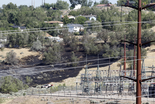 Al Hartmann  |  The Salt Lake Tribune
View of burned field just to the east of a Rocky Mountain Power substation at the mouth of Ogden Canyon Tuesday morning July 3.  The fire came within a few feet of a condominium complex further east.