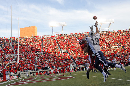 Tribune file photo
Jonny Harline battles Eric Weddle as he snags a pass for BYU during a game at Rice-Eccles Stadium.