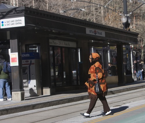 Al Hartmann  |  The Salt Lake Tribune
Dangerous violations of safety rules -- such as this pedestrian jaywalking across Main Street tracks in Salt Lake City -- abound around TRAX trains. UTA has a new ordinance that enables transit police to cite people for 