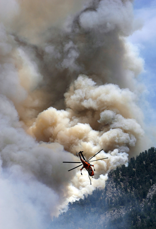 Francisco Kjolseth  |  The Salt Lake Tribune
Air crews continue to battle the blaze above Alpine on Wednesday, July 4, 2012, with multiple helicopters targeting hot spots along the steep mountain sides. The wildfire which started Tuesday afternoon in Lambert Park continued its move South and up the slopes, however some evacuated neighborhoods had been allowed to return.