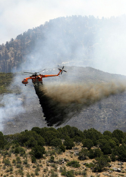 Francisco Kjolseth  |  The Salt Lake Tribune
Air crews continue to battle the blaze above Alpine on Wednesday, July 4, 2012, with multiple helicopters targeting hot spots along the steep mountain sides. The wildfire which started Tuesday afternoon in Lambert Park continued its move South and up the slopes, however some evacuated neighborhoods had been allowed to return.
