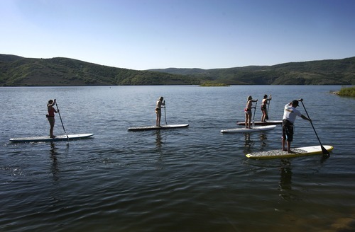 Rick Egan  | The Salt Lake Tribune 

Trent Hickman (right) gives a lesson on stand up paddle boarding to the Hale sisters from Ft Lauderdale, Florida, at Jordanelle Reservoir, Thursday, June 14, 2012.