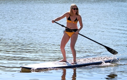 Rick Egan  | The Salt Lake Tribune 

 Sarah Hale, 18, from Ft Lauderdale, Florida, races her sister to the shore on a stand up paddle board at Jordanelle Reservoir, Thursday, June 14, 2012.