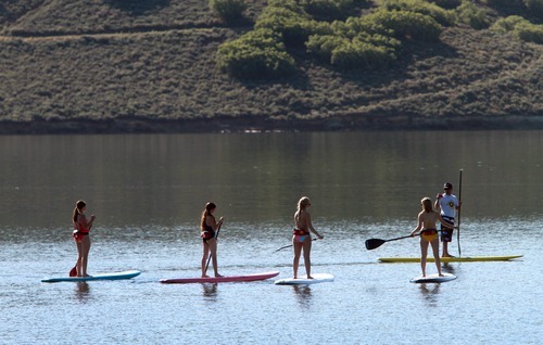 Rick Egan  | The Salt Lake Tribune 

Trent Hickman (right) gives a lesson on stand up paddle boarding to the Hale sisters from Ft Lauderdale, Florida, at Jordanelle Reservoir, Thursday, June 14, 2012.