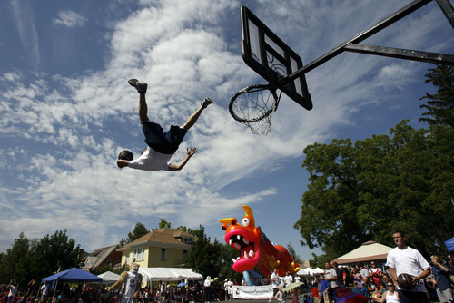 Francisco Kjolseth  |  The Salt Lake Tribune
David Eberhard with BYU athletics soars through the air for a dunk as thousands line the streets of downtown Provo to watch the Freedom Festival Parade on Wednesday, July 4, 2012.