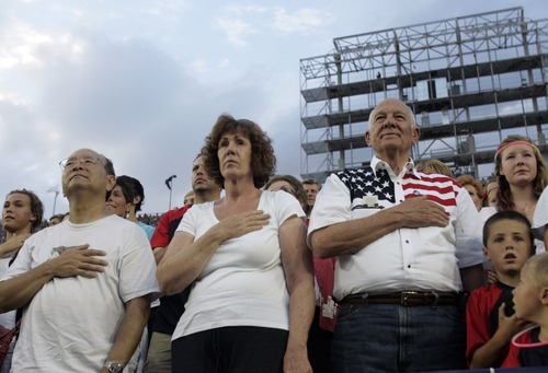 Kim Raff | The Salt Lake Tribune
People stand during the National Anthem during the Stadium of Fire at the LaVell Edwards Stadium in Provo, Utah on July 4, 2012.
