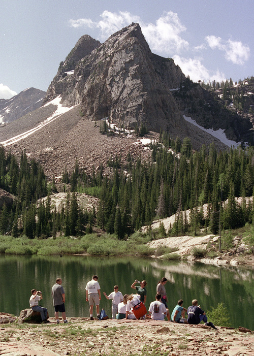 Tribune file photo
Day hikers take a break at the top of  Lake Blanche with Sundial Peak behind in Big Cottonwood Canyon.