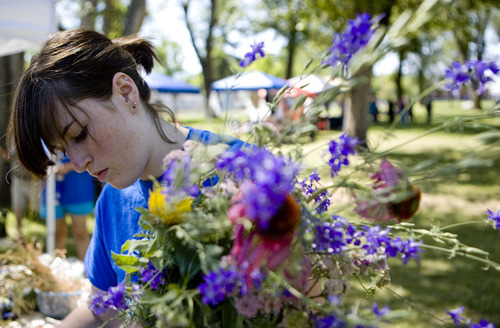 Kim Raff | The Salt Lake Tribune
Fiona Spas prepares a flower bouquet to sell during The People's Market that began its 7th season July 8 with local produce, crafts and entertainment at the International Peace Gardens in Salt Lake City. The market will be open every Saturday from 10 a.m.-3 p.m.
