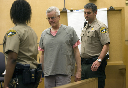 Kim Raff | Tribune file photo
After a recess, Steve Powell is led into his sentencing hearing for his conviction on 14 felony counts of voyeurism in the Pierce County Superior Court in Tacoma, Wash., on June 15, 2012. Powell was given a sentence of 30 months.