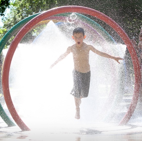 Rick Egan  | The Salt Lake Tribune 

Seven-year-old Caleb Collins cools off in one of the fountains at Liberty Park on Monday, July 9, 2012.