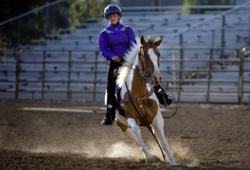 Kim Raff | The Salt Lake Tribune
River Schiffman rides Rikkii during the horse trail course during the 4-H Horse Show at the South Jordan Equestrian Park in South Jordan, Utah on July 6, 2012.  This year marks the 100th anniversary of 4-H in Utah.
