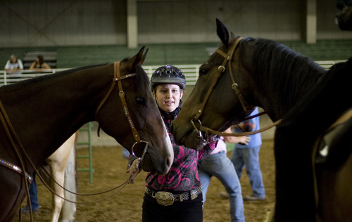 Kim Raff | The Salt Lake Tribune
McKenzie Sanders holds onto (left) Deal and Jake during the 4-H Horse Show at the South Jordan Equestrian Park in South Jordan, Utah on July 6, 2012.  This year marks the 100th anniversary of 4-H in Utah.