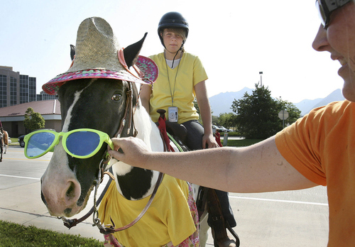 Scott Sommerdorf  |  Tribune file photo
Sierra Engle's horse, Ace, endures the indignity of wearing a tourist costume including goofy sunglasses at the Days of '47 Horse Parade in July 2008. The Days of '47 celebration honors the pioneers who trekked westward to settle Utah in 1847.