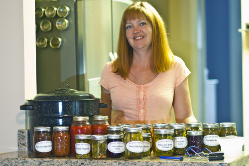 Chris Detrick  |  The Salt Lake Tribune
Alison Einerson poses for a portrait with some of her pickled foods at her home in Salt Lake City Wednesday July 11, 2012. She has been pickling for over seven years and usually produces over 300 jars a year, using several dozen varieties of vegetables. Einerson is teaching several canning and pickling classes this summer through Wasatch Community Gardens and The Downtown Farmers Market.