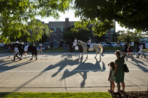 Chris Detrick  |  The Salt Lake Tribune
Petra Stark and her daughter Marley, 6, of Sandy, watch as junior members of the Utah Dressage Society ride during the Days of '47 All-Horse Parade Tuesday July 10, 2012.