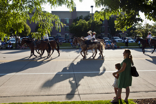 Chris Detrick  |  The Salt Lake Tribune
Petra Stark and her daughter Marley, 6, of Sandy, watch as members of the Pony Express Jr. Posse ride during the Days of '47 All-Horse Parade Tuesday July 10, 2012.