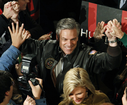 Republican presidential candidate former Utah Gov. Jon Huntsman follows his wife, Mary Kaye, as they enter a campaign rally in Exeter, N.H., Monday, Jan. 9, 2012. (AP Photo/Elise Amendola)