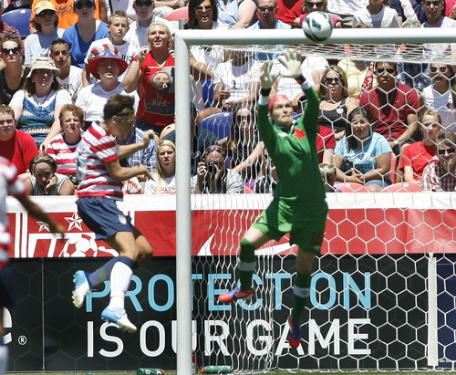 Scott Sommerdorf  |  The Salt Lake Tribune             
Canada goalkeeper Erin McLeod (18) grabs the ball and thwarts USA forward Abby Wambach's header. The U.S. women's national team beat Canada 2-1 in its final match before going to the London Olympics, Saturday, June 30, 2012.