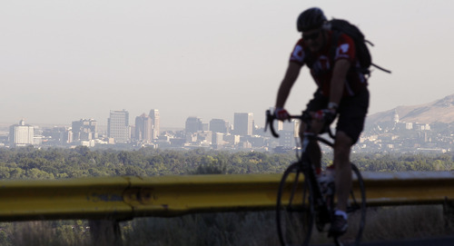 Al Hartmann  |  The Salt Lake Tribune  
Bicyclist takes in an early morning ride along Wasatch Blvd. above the Salt Lake Valley. City officials are taking steps to make bicycle commuting more safe.