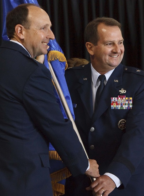 Leah Hogsten  |  The Salt Lake Tribune
Brig. Gen. H. Brent Baker, the new commander of the Ogden Air Logistics Complex, right, assumes command under Lt. Gen. Bruce Litchfield, commander of the Air Force Sustainment Center Thursday. Restructuring at the Ogden Air Logistics Center at Hill Air Force Base left it with a new name and commander Thursday, July 12, 2012. The new Ogden Air Logistics Complex is part of a major reorganization of the Air Force's Materiel Command, which is the service's biggest employer of civilians. The Air Force expects to save $109 million a year by reducing and consolidating overhead.