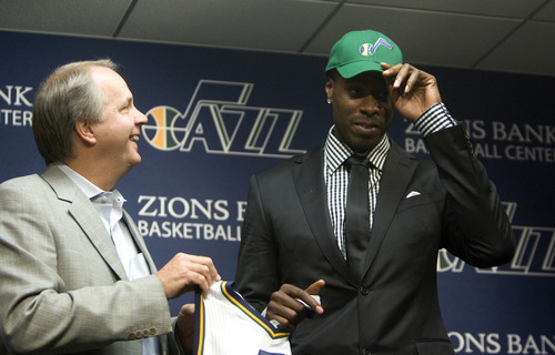Kim Raff | The Salt Lake Tribune
(left) Utah Jazz president Randy Rigby stands on stage with new trade acquisition Marvin Williams during a press conference to introduce Williams at the Jazz practice facility in Salt Lake City, Utah on July 12, 2012.