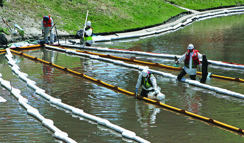 Francisco Kjolseth  |  Tribune file photo  
Cleanup from the Red Butte Creek oil spill continues Monday, June 28, 2010, as crews wipe down multiple booms set up at the Liberty Park pond.