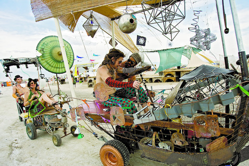 Kim Raff | The Salt Lake Tribune
(middle left) Ian Prowess and Coulson Rich drive an art car around Element 11, a regional Burning Man event, at the Bonneville Sea Base in Tooele County, Utah on July 13, 2012.