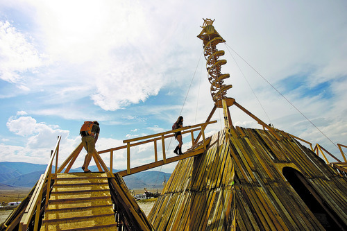 Kim Raff | The Salt Lake Tribune
People walk up the Main Effigy, a structure that will be burned during the event, at Element 11, a regional Burning Man event, at the Bonneville Sea Base in Tooele County, Utah on July 13, 2012.