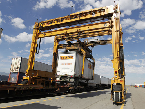 Al Hartmann  |  The Salt Lake Tribune  
Huge moving crane off loads semi truck trailors with goods  from rail cars at Union Pacific's intermodal shipping container hub at 5600 West and 10th South. The huge hub offloads containers from trains and trucks pickup the loads for delivery troughout the intermountain west.