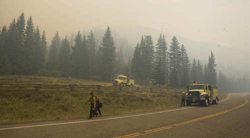 Paul Fraughton  |  The Salt Lake Tribune
Firefighters are stationed near the Stuart Guard Station in Huntington Canyon on Wednesday, June 27, 2012, to protect the historic building from the Seeley Fire burning in the Manti-La Sal National Forest.