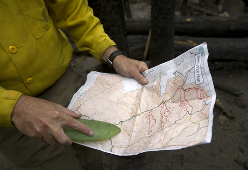 Kim Raff | The Salt Lake Tribune
Brian McInerney, a hydrologist for the National Weather Service and member of the Burned Area Emergency Response, shows a map of the fire devastated area that is a concern for debris slides that are a result of the Seeley Fire in Carbon County, Utah, on July 15, 2012.  After a serious forest fire the ground in the burned area becomes unstable and can cause large debris slides.