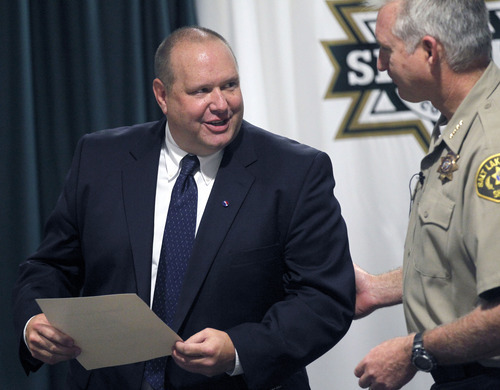 Al Hartmann  |  The Salt Lake Tribune  
Unified Police Detective Todd Park, left, accepts certificate from Sheriff Jim WInder Wednesday July 18.  Park was recognized for his outstanding work and dedication to solving cold-case homicides.