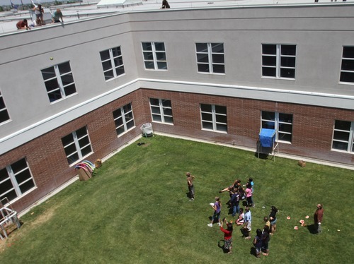 Rick Egan  | The Salt Lake Tribune 

Students from Copper Hills High built devices in an attempt to catch watermelons dropped from the roof of their school as part of a science and physics grant the school received.