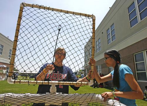 Rick Egan  | The Salt Lake Tribune
Thekla Hughes, left, and Tiana Rowley, work on their watermelon catching devices along with other students from Copper Hills School. Students built devices in an attempt to catch watermelons dropped from the roof of their school as part of a science and physics grant the school received.