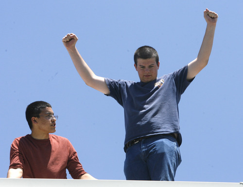 Rick Egan  | The Salt Lake Tribune 

James Khang (left) and Wyatt McNeil (right) celebrate as their watermelon was caught intact. Students built devices in an attempt to catch watermelons dropped from the roof of their school as part of a science and physics grant.